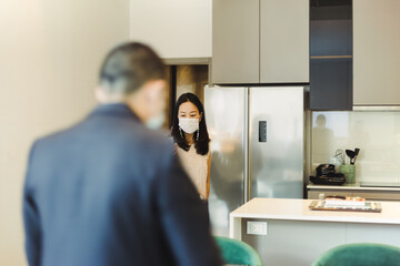 Woman in protective mask video call on cell phone with male real estate agent.