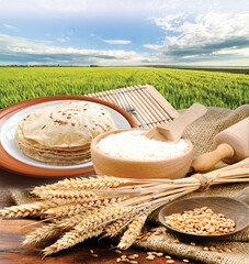 Wheat flour, Chapati, Roti, Bunch of wheat ears, dried grains, flour in terracota bowl on Wheat...