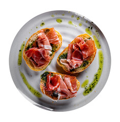 Bruschetta with prosciutto and pesto sauce on plate isolated on white background