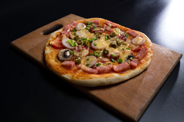 Pizza on kitchen board. Ready fresh pizza.