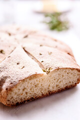 Homemade fresh baked Fougasse (French Bread) with thyme and olive oil on white background. Traditional Provencal dishes. Selective focus