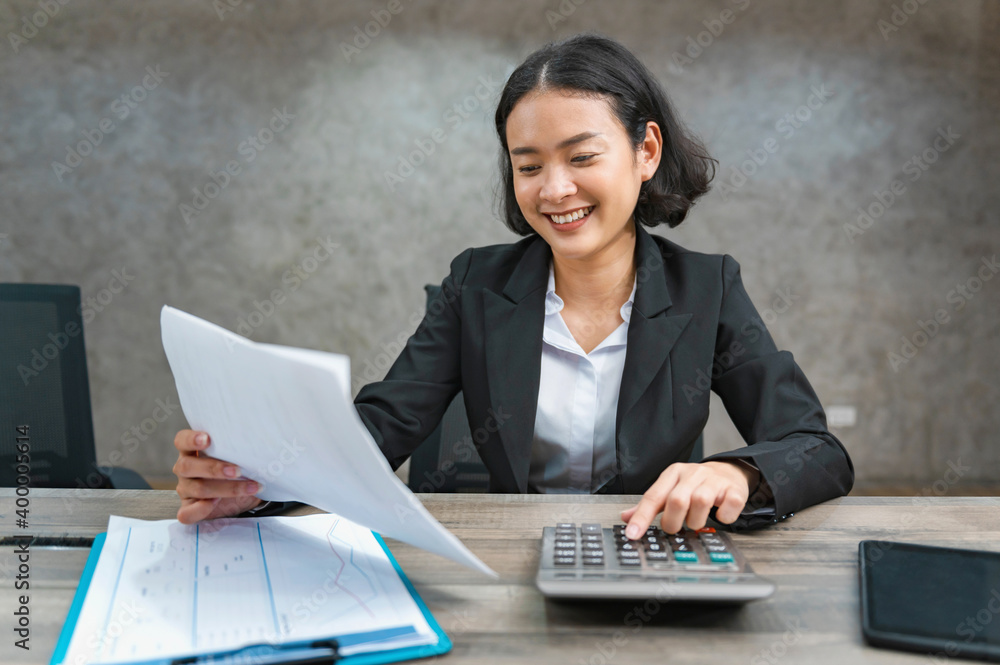 Poster woman accountant using calculator for calculate finance report in office