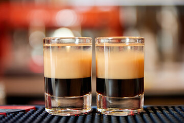 Multicolored alcoholic drinks shots on the bar counter