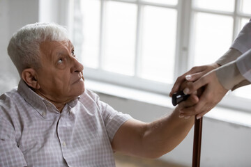 Disabled elderly male receive help compassion aid from home care nurse retreat center staff. Mature...