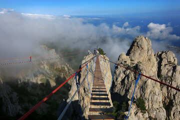 Tourists on a suspension bridge in the Ai-Petri mountains in Crimea