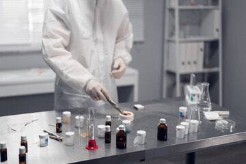 Chemical laboratory in action. A scientific researcher setting on fire the material he is testing.