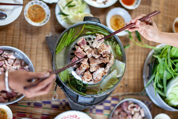 Moo Kra Ta , Thai traditional barbecue grill pork on hot pan with soup and vegatables.