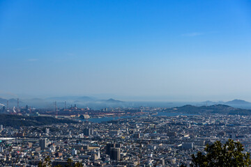 Fototapeta na wymiar Fukuyama City seen from the top of the mountain. (Residential and industrial area)