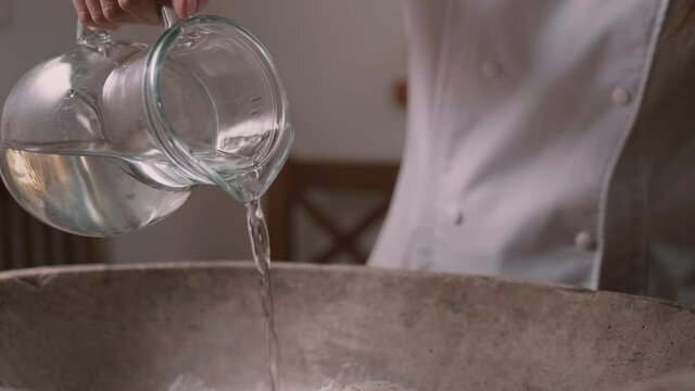 Person pouring water from a pitcher