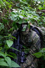 Croatia recon forces soldier camouflaging in the forest with the 
Cropat woodland uniform and...
