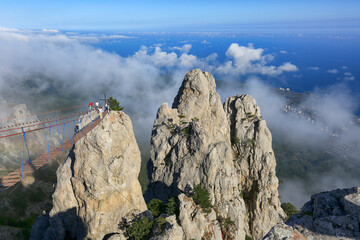 Tourists on a suspension bridge in the Ai-Petri mountains in Crimea