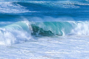 Perfect waves breaking perfectly in a beach