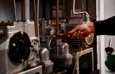 Workers are using wrenches to repair the inside of the tanker