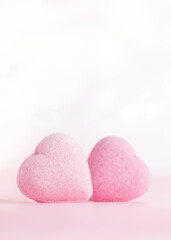 Obraz premium Valentines day greeting card , two pink candy hearts on gentle pink background with copy space .Vertical .