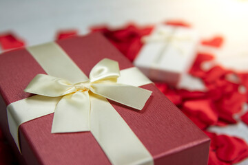 gift boxes for the holiday Valentine's Day. Red and white boxes with gold ribbons. White wooden...