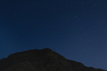 horizontal landscape at night with blue sky full of stars and rocky mountains, Lima Peru