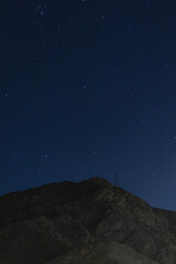 blue starry night sky with rocky mountains background in Lima Peru