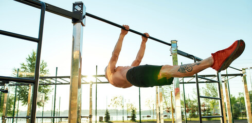 Sportsman performing statics exercise during street workout