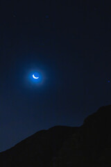 Fototapeta na wymiar Waning crescent moon in dark night sky with mountains debajo in Lima Peru