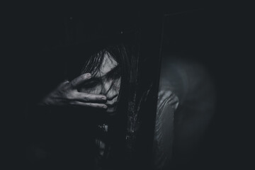 Portrait of asian woman make up ghost face with blood,Horror scene,Scary background,Halloween poster,Thailand people,Ghost movies poster