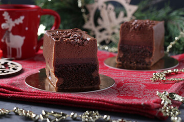 Chocolate brownie with raspberry confit and coffee mousse covered gourmet chocolate glaze on new year background. Closeup.