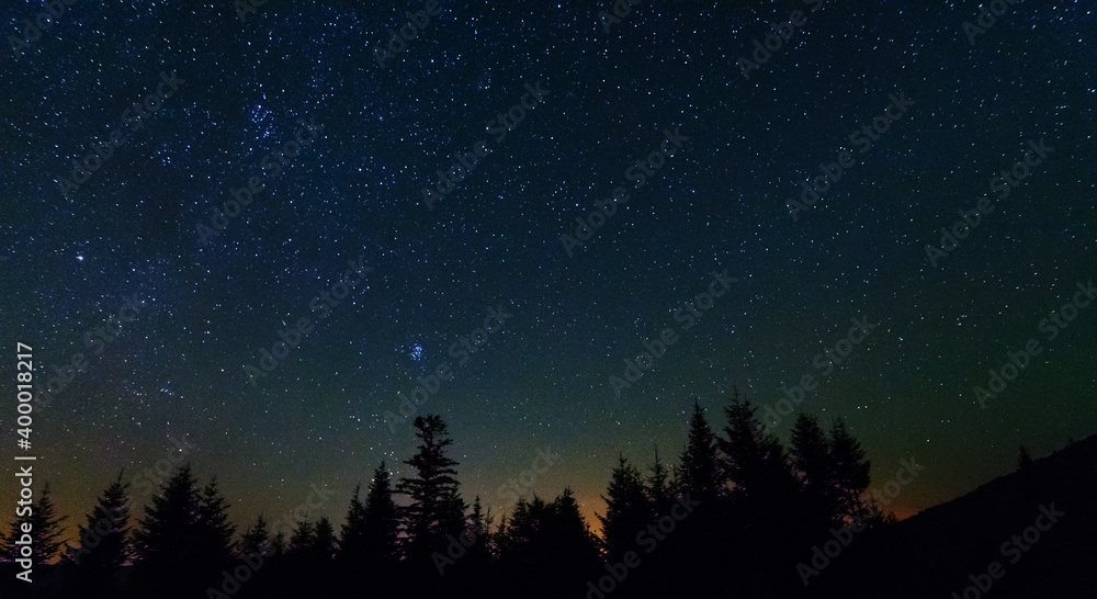Wall mural fantastic starry night with galaxy milky way with a tourist and a tent on the mountain range in the 