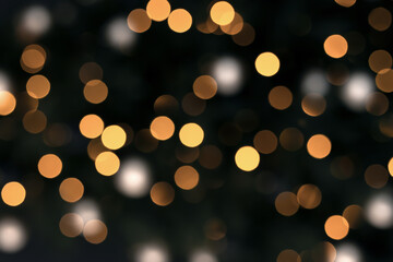 Gold bokeh on a black background. New year festive background