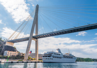 Fototapeta premium Bridge across the bay in the Adriatic sea and tourist ships near the city of Dubrovnik, Croatia
