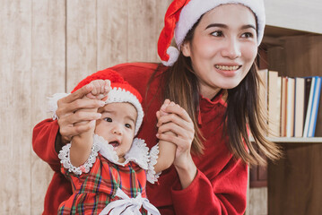 merry christmas and happy holidays. cheerful mom and her cute daughter girl. parent and little child having fun indoors. loving family.