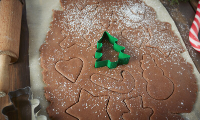 Christmas baking, gingerbread dough, cookie cutters and twigs of fur