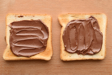 Close-up of two bread toast spread with chocolate-nut paste top view