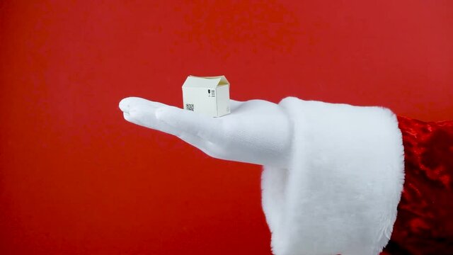 Santa hand with Amazon paper box. Online shopping concept. Cardboard boxes for the delivery of goods. Packages delivery, parcels transportation system concept. Omsk, Russia - December 6, 2020