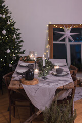 Beautiful christmas composition with a Christmas tree, candles, decorations on textured table. Close up, copy space, background.