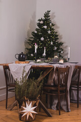 Beautiful christmas composition with a Christmas tree, candles, decorations on textured table. Close up, copy space, background.