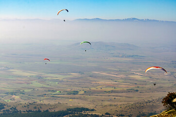 Paragliders flying over the clouds. No limits, paragliding above the clouds