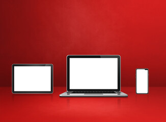 Laptop, mobile phone and digital tablet pc on red office desk