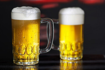Glasses of beer on the dark background