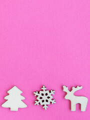 Wooden Christmas toys on pink background
