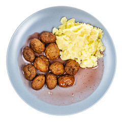 top view of cooked swedish meatballs with lingonberry sauce and mashed potatoes on blue plate isolated on white background