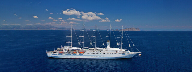 Aerial drone ultra wide photo of luxury sailing boat anchored in Mediterranean deep blue sea