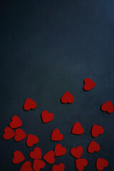 hearts, balloons and chocolate on black stone background