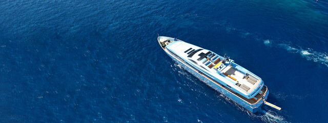 Aerial drone top down ultra wide photo of luxury yacht cruising in low speed in Mediterranean deep...