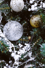 Christmas tree branches decorated with silver festive balls and ornaments. New year 2021 mood