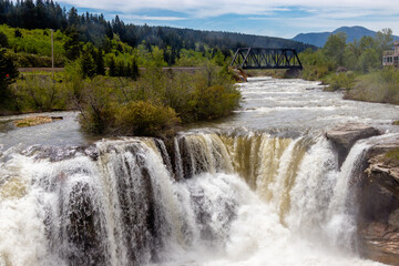 Fototapeta na wymiar Thunder water over te falls in early spring. Lundbeck Falls PRA, Alberta, Canada