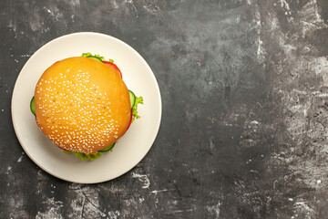 Obraz na płótnie Canvas top view tasty chicken burger with vegetables on a dark background sandwich fast-food bun
