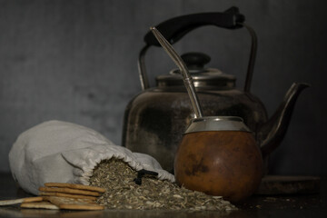 Shot of a brown calabash, a kettle and a bag filled with tea herb called mate