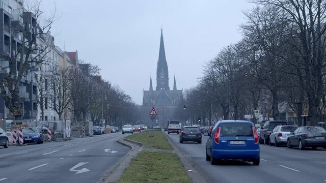 Traffic on Berlin street Hasenheide in Kreuzberg with S&uuml;dstern Church in the background on a cold winter day. Shot in 6K braw.