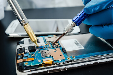 Fototapeta na wymiar technician repairing inside of hard disk by soldering iron. Integrated Circuit. the concept of data, hardware, technician and technology.