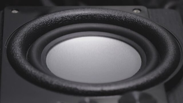 Black bass woofer. Modern speacker loud sound. Slow motion footage.