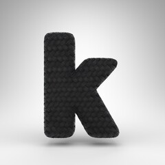 Letter K lowercase on white background. Black carbon fiber 3D letter with carbon thread texture.